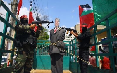 Palestinian militants from the Popular Front for the Liberation of Palestine (PFLP) aim their weapons at an effigy depicting US President Donald Trump as they ride a truck during a protest in Gaza City, May 23, 2017. (AFP/MOHAMMED ABED)