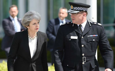 Britain's Prime Minister Theresa May, left, walks with Chief Constable of Greater Manchester Police Ian Hopkins as she arrives at the force's headquarters in Manchester, northwest England on May 23, 2017 following a deadly terror attack at a concert at the Manchester Arena the night before. (Oli Scarff/AFP)