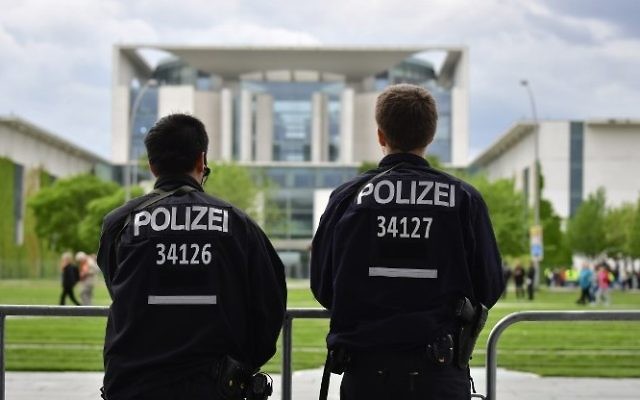 Illustrative: Police officers stand in front of the chancellery in Berlin, on May 24, 2017. (AFP/John MacDougall) Illustrative: Police officers stand in front of the chancellery in Berlin, on May 24, 2017. (AFP/John MacDougall)