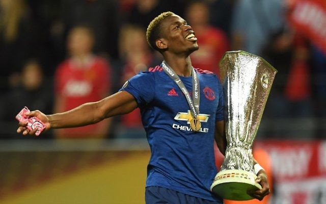 Manchester United's French midfielder Paul Pogba celebrates with the trophy after during the UEFA Europa League final football match Ajax Amsterdam v Manchester United on May 24, 2017 at the Friends Arena in Solna outside Stockholm. (AFP /Paul ELLIS)