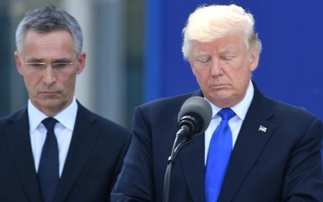 US President Donald Trump, right, stands next to NATO Secretary General Jens Stoltenberg, left, during the unveiling ceremony of the Berlin Wall monument, during the NATO (North Atlantic Treaty Organization) summit at the NATO headquarters, in Brussels, on May 25, 2017. (AFP/ Emmanuel DUNAND) US President Donald Trump, right, stands next to NATO Secretary General Jens Stoltenberg, left, during the unveiling ceremony of the Berlin Wall monument, during the NATO (North Atlantic Treaty Organization) summit at the NATO headquarters, in Brussels, on May 25, 2017. (AFP/ Emmanuel DUNAND)