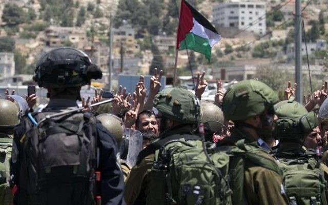 Palestinians take part in a violent protest in front of Israeli security forces following a Friday afternoon prayer service in solidarity with Palestinian security prisoners, outside Nablus on May 26, 2017. (Jaafar Ashtiyeh/AFP Photo)