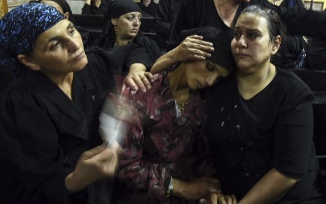 Relatives of killed Coptic Christians grieve during the funeral at Abu Garnous Cathedral in the north Minya town of Maghagha, Egypt on May 26, 2017. (AFP PHOTO / MOHAMED EL-SHAHED) Relatives of killed Coptic Christians grieve during the funeral at Abu Garnous Cathedral in the north Minya town of Maghagha, Egypt on May 26, 2017. (AFP PHOTO / MOHAMED EL-SHAHED)