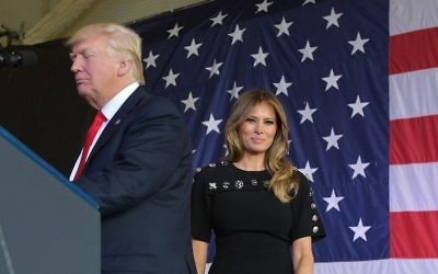 US First Lady Melania Trump smiles on stage next to her husband US President Donald Trump during a meeting with US military personnel and families at Naval Air Station Sigonella after G7 summit of Heads of State and Government, on May 27, 2017 near Taormina in Sicily. (AFP PHOTO / MANDEL NGAN) US First Lady Melania Trump smiles on stage next to her husband US President Donald Trump during a meeting with US military personnel and families at Naval Air Station Sigonella after G7 summit of Heads of State and Government, on May 27, 2017 near Taormina in Sicily. (AFP PHOTO / MANDEL NGAN)