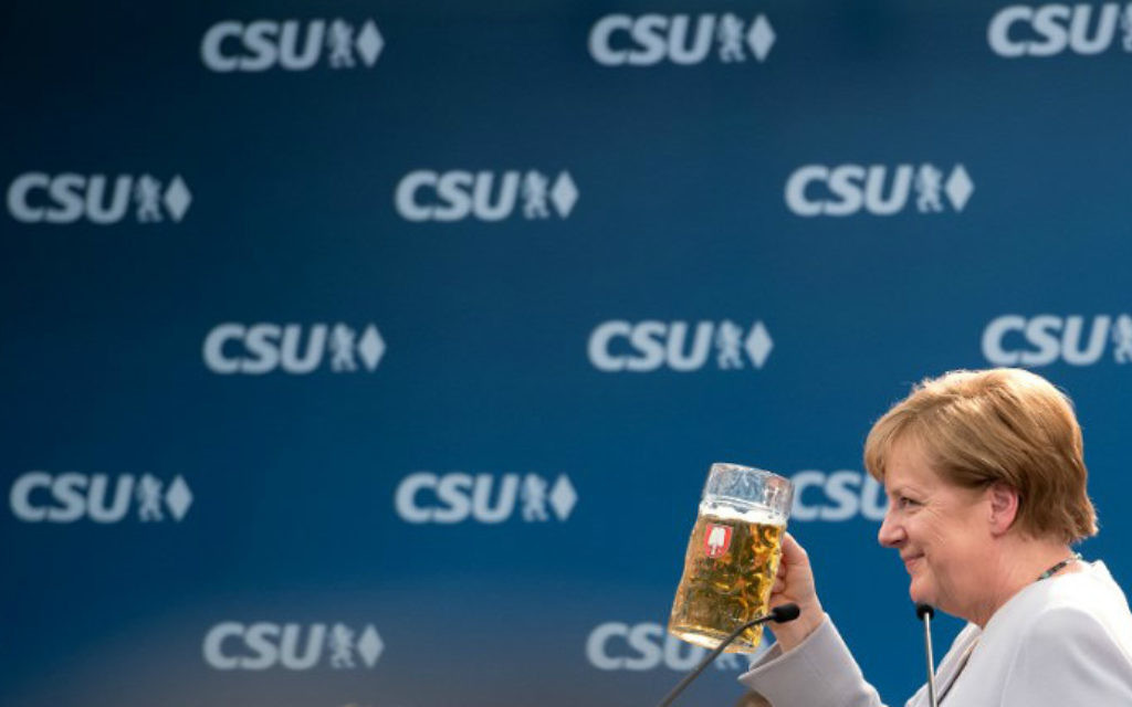 German Chancellor Angela Merkel takes a sip of beer after delivering a speech during a joint campaigning event of the Christian Democratic Union (CDU) and the Christian Social Union (CSU) in Munich, southern Germany, on May 27, 2017. (Sven Hoppe/dpa/AFP)
