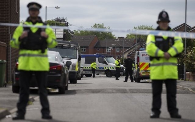 Police officers guard the entrance to a street in the Moss Side area of Manchester on May 28, 2017 during an operation. (AFP/ JOHN SUPER) Police officers guard the entrance to a street in the Moss Side area of Manchester on May 28, 2017 during an operation. (AFP/ JOHN SUPER)