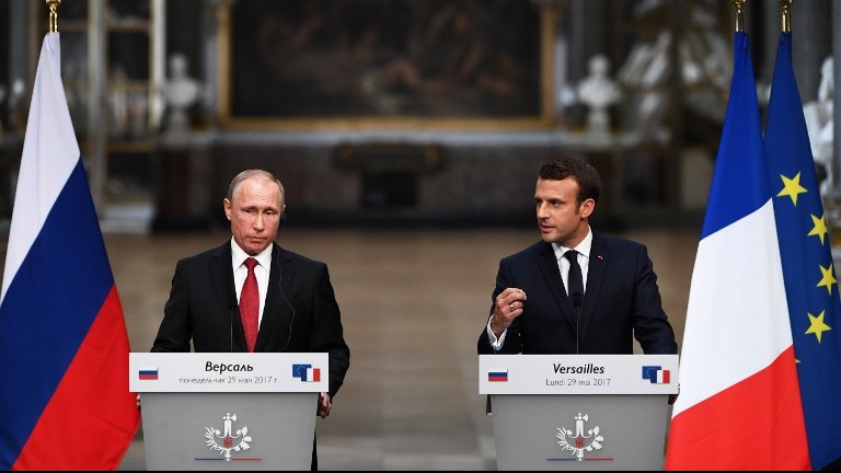 French President Emmanuel Macron (R) gestures as he speaks during a joint press conference with Russian President Vladimir Putin (L) following their meeting at the Versailles Palace, near Paris, on May 29, 2017. (AFP Photo/Christophe Archambault) French President Emmanuel Macron (R) gestures as he speaks during a joint press conference with Russian President Vladimir Putin (L) following their meeting at the Versailles Palace, near Paris, on May 29, 2017. (AFP Photo/Christophe Archambault)
