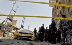 Iraqis gather at the site of a car bomb explosion near Baghdad's Al-Shuhada Bridge on May 30, 2017. (AFP/Sabah Arar)