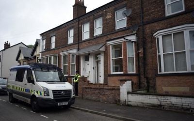 Police officers stand guard outside a property on Springfield Street in Wigan, northern England on May 30, 2017, following a raid on a residential property as their investigations continues into the May 22 terror attack at the Manchester Arena. (AFP)