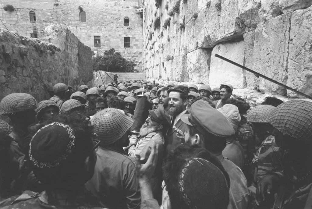 A group of paratroopers surrounds then-IDF chief rabbi Shlomo Goren at the Western Wall on June 7, 1967. (Micha Bar-Am/Defense Ministry's IDF Archive) A group of paratroopers surrounds then-IDF chief rabbi Shlomo Goren at the Western Wall on June 7, 1967. (Micha Bar-Am/Defense Ministry's IDF Archive)