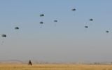 Paratroopers make their way down to earth during a parachuting exercise in central Israel on February 19, 2014. (IDF Spokesperson's Unit/Flickr)