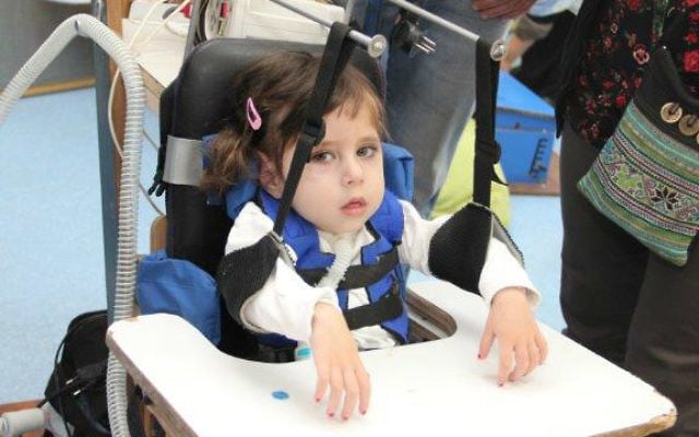 A child using ALYN's hand support development (Courtesy)