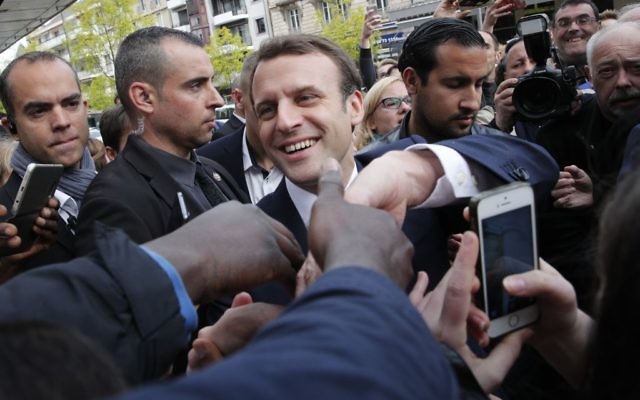 French independent centrist presidential candidate Emmanuel Macron shakes hands to supporters as he campaigns in Rodez, southern France, Friday, May 5, 2017. (AP Photo/Christophe Ena)