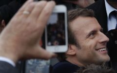 French independent centrist presidential candidate Emmanuel Macron shakes hands with well-wishers as he leaves the polling station after casting his ballot in the presidential runoff election in Le Touquet, France, Sunday, May 7, 2017. (AP/Christophe Ena)