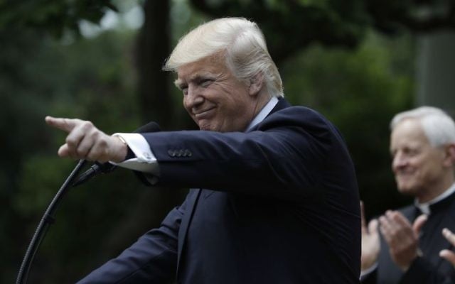 President Donald Trump gestures while speaking in the Rose Garden of the White House in Washington, Thursday, May 4, 2017, before signing an executive order aimed at easing an IRS rule limiting political activity for churches. (AP Photo/Evan Vucci)