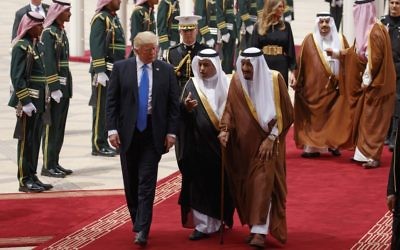 President Donald Trump walks with Saudi King Salman during a welcome ceremony at the Royal Terminal of King Khalid International Airport, on May 20, 2017, in Riyadh. (AP Photo/Evan Vucci)