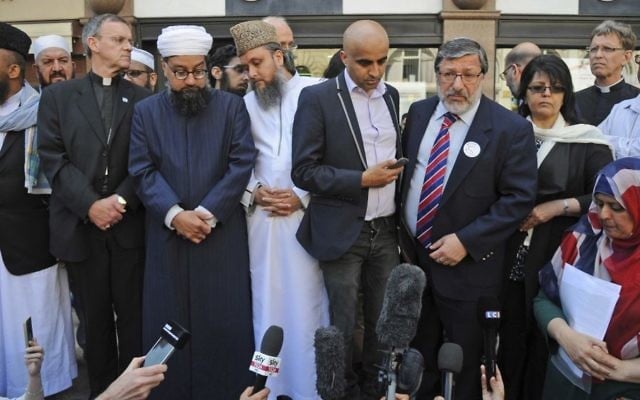 Religious leaders address crowds during a vigil at St Ann's square in central Manchester, England, Wednesday May 24 2017. (AP Photo/Rui Vieira) 