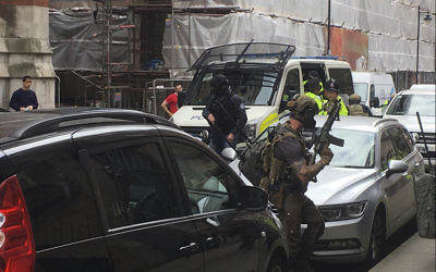 Police from the Tactical Aid Unit  prepare to enter Granby House apartments in Manchester England, Wednesday, May 24, 2017  in connection to Monday's Manchester explosion. (AP/Louise Bolotin)