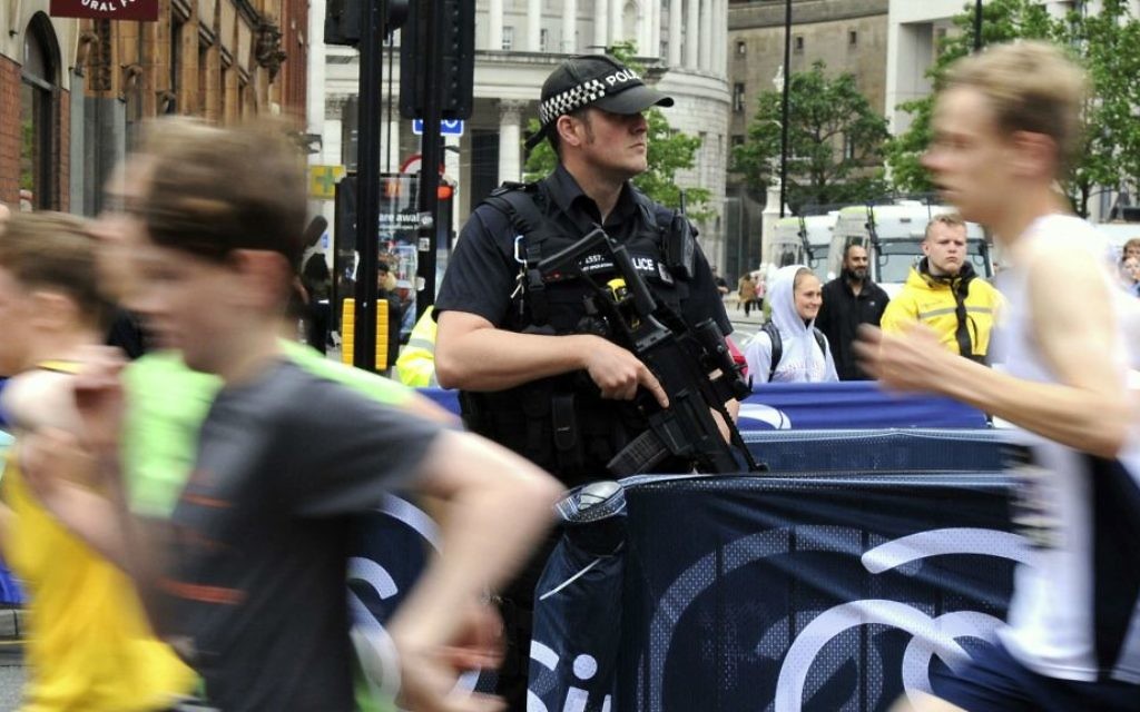 Armed police guard the Great Manchester Run in Manchester, England Sunday, May 28, 2017. (AP Photo/Rui Vieira)