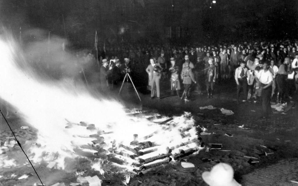 A crowd gathers to witness thousands of books, considered to be "un-German," burn in Opera Square in Berlin, Germany, during the Buecherverbrennung book burnings on May 10, 1933. (AP Photo)