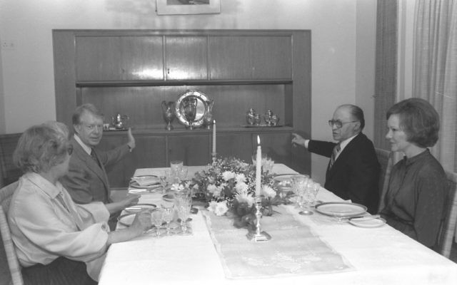 US President Jimmy Carter, left, with Prime Minister Menachem Begin, and their respective wives having dinner at the prime minister's residence in Jerusalem, March 1979 (Yaacov Saar/GPO)