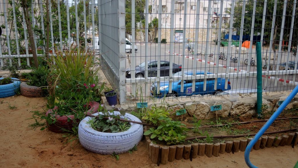 The garden at Rivkie's nursery school in Modiin Illit on March 22, 2017. Leshomra built the right side, while Rivkie enlarged the garden with tires on the left. (Melanie Lidman/Times of Israel)