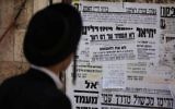 Illustrative: An ultra-Orthodox Jewish man reads a pashkevil on August 1, 2013. (Yonatan Sindel/Flash90)