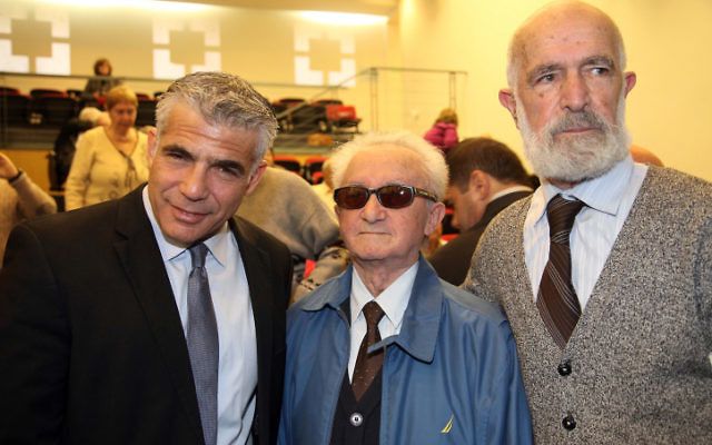 Illustrative: Yesh Atid Chairman Yair Lapid (left), at the Holot Institute of Technology for the Holocaust Survivors Conference on December 29, 2014. (Flash90) Illustrative: Yesh Atid Chairman Yair Lapid (left), at the Holot Institute of Technology for the Holocaust Survivors Conference on December 29, 2014. (Flash90)