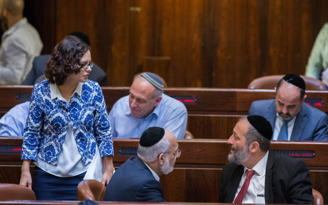 Interior Minister Aryeh Deri (R) speaks with Kulanu MK Rachel Azaria (L) during a plenum session in the assembly hall of the Israeli parliament on July 15, 2015. (Yonatan Sindel/Flash90) 