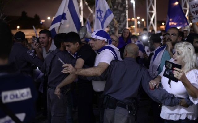 Israelis protest against a memorial ceremony commemorating both Israeli and Palestinian victimes of terror in the Israeli-Palestinian conflict in Tel Aviv on April 30, 2017, as Israel marks the annual Memorial Day for Fallen Soldiers. (Tomer Neuberg/Flash90) Israelis protest against a memorial ceremony commemorating both Israeli and Palestinian victimes of terror in the Israeli-Palestinian conflict in Tel Aviv on April 30, 2017, as Israel marks the annual Memorial Day for Fallen Soldiers. (Tomer Neuberg/Flash90)