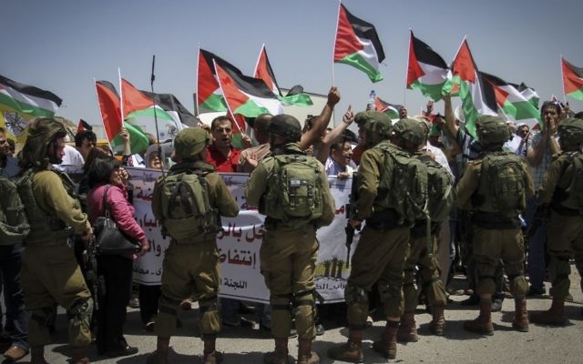 Israeli soldiers stop Palestinians during a demonstration at Hawara checkpoint, in the West Bank city of Nablus on May 11, 2017. (Nasser Ishtayeh/Flash90) Israeli soldiers stop Palestinians during a demonstration at Hawara checkpoint, in the West Bank city of Nablus on May 11, 2017. (Nasser Ishtayeh/Flash90)