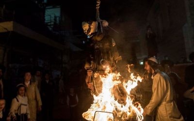 Ultra-Orthodox Jews burn an effigy of an IDF soldier during Lag B'Omer celebrations in the ultra-orthodox neighborhood of Mea She'arim in Jerusalem on May 13, 2017. (Noam Revkin Fenton/Flash90)