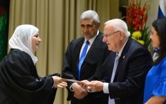 Justice Minister Ayelet Shaked, President Reuven Rivlin, and President of the Shariya Court of Appeals, the Qadi Abed Alhakim Samara, give a certificate to the newly appointed first female Qadi, Hana Mansour Khatib at the president's residence, on May 15, 2017. (Mark Neyman/GPO)