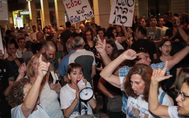 Protesters demonstrate outside the home of Attorney General Avichai Mendelblit in Petah Tikva, on May 27, 2017. (Roy Alima/Flash90) Protesters demonstrate outside the home of Attorney General Avichai Mendelblit in Petah Tikva, on May 27, 2017. (Roy Alima/Flash90)