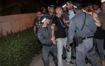 Police arrest a protester during a demonstration outside the home of Attorney General Avichai Mendelblit in Petah Tikva, on May 27, 2017. (Roy Alima/Flash90)