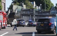 Police investigate a deadly stabbing on a Metropolitan Area Express train in northeast Portland, Ore., Friday, May 26, 2017. (Jim Ryan/The Oregonian via AP)