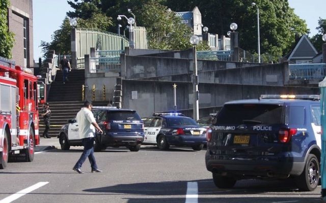 Police investigate a deadly stabbing on a Metropolitan Area Express train in northeast Portland, Ore., Friday, May 26, 2017. (Jim Ryan/The Oregonian via AP) Police investigate a deadly stabbing on a Metropolitan Area Express train in northeast Portland, Ore., Friday, May 26, 2017. (Jim Ryan/The Oregonian via AP)