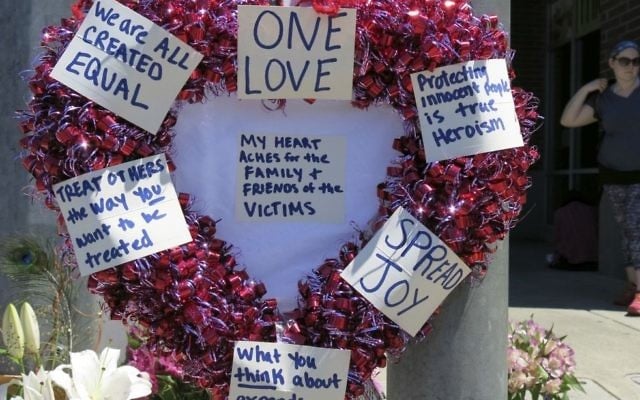 A heart-shaped wreath covered with positive messages hangs on a traffic light pole at a memorial for two bystanders who were stabbed to death trying to stop a man who was yelling anti-Muslim slurs on a light-trail train in Portland, Oregon on May 27, 2017. (AP Photo/Gillian Flaccus) A heart-shaped wreath covered with positive messages hangs on a traffic light pole at a memorial for two bystanders who were stabbed to death trying to stop a man who was yelling anti-Muslim slurs on a light-trail train in Portland, Oregon on May 27, 2017. (AP Photo/Gillian Flaccus)
