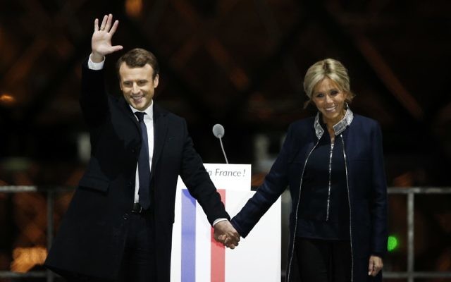 French President-elect Emmanuel Macron holds hands with his wife Brigitte during a victory celebration outside the Louvre museum in Paris, France, Sunday, May 7, 2017. (AP Photo/Thibault Camus) French President-elect Emmanuel Macron holds hands with his wife Brigitte during a victory celebration outside the Louvre museum in Paris, France, Sunday, May 7, 2017. (AP Photo/Thibault Camus)