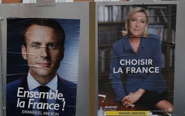 Election campaign posters for French centrist presidential candidate Emmanuel Macron and far-right candidate Marine Le Pen are displayed in front of the polling station where Marine Le Pen will vote in Henin Beaumont, northern France, Saturday, May 6, 2017. (AP Photo/Francois Mori) Election campaign posters for French centrist presidential candidate Emmanuel Macron and far-right candidate Marine Le Pen are displayed in front of the polling station where Marine Le Pen will vote in Henin Beaumont, northern France, Saturday, May 6, 2017. (AP Photo/Francois Mori)