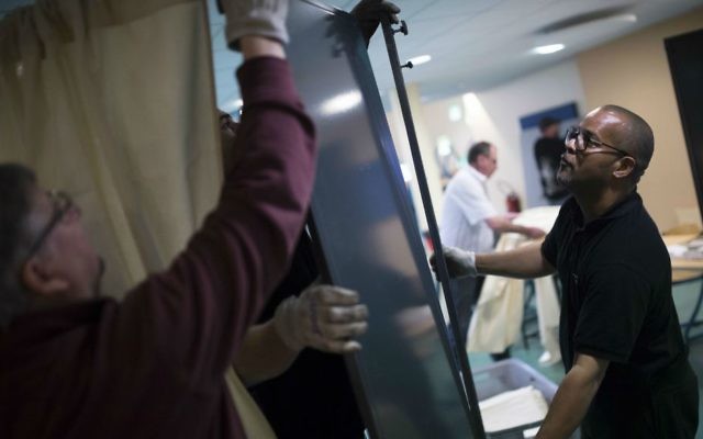 Workers prepare the booths at a polling station in Saint Cloud, outside Paris, France, Saturday, May 6, 2017. (AP Photo/Kamil Zihnioglu) Workers prepare the booths at a polling station in Saint Cloud, outside Paris, France, Saturday, May 6, 2017. (AP Photo/Kamil Zihnioglu)