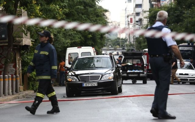 Members of the emergency services walk by a car, near the scene of an explosion, in Athens, Thursday, May 25, 2017. (AP Photo/Yorgos Karahalis) Members of the emergency services walk by a car, near the scene of an explosion, in Athens, Thursday, May 25, 2017. (AP Photo/Yorgos Karahalis)