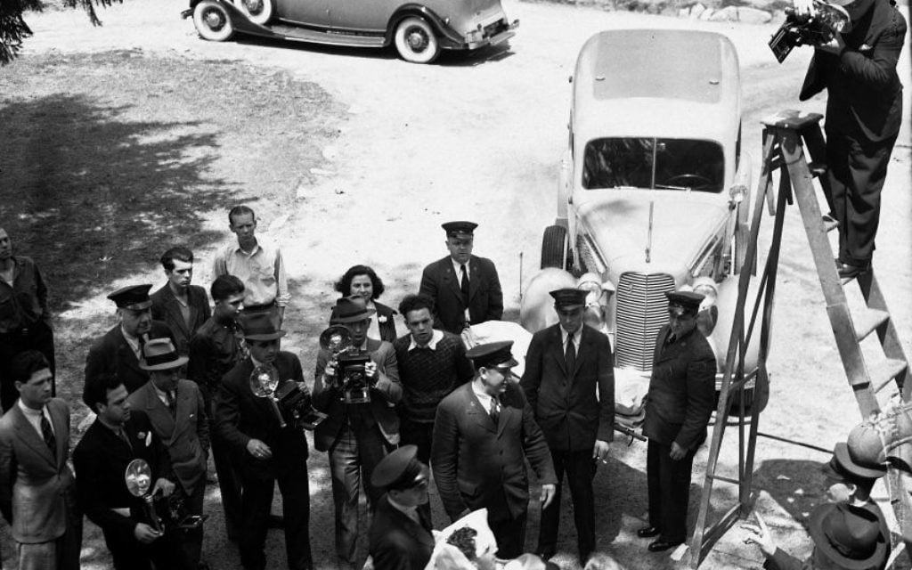 In this May 7, 1937 photo, news photographers take pictures of an unidentified survivor of the German dirigible Hindenburg disaster the previous day (AP Photo, File)