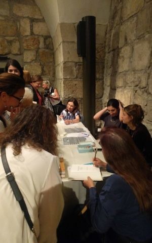 Ora Ahimeir signs books after her discussion with Anne-Marie O'Connor for the Personal Pages: Meet the Authors series at the Tower of David Museum in Jerusalem's Old City, May 15, 2017. (Yaakov Schwartz/Times of Israel)
