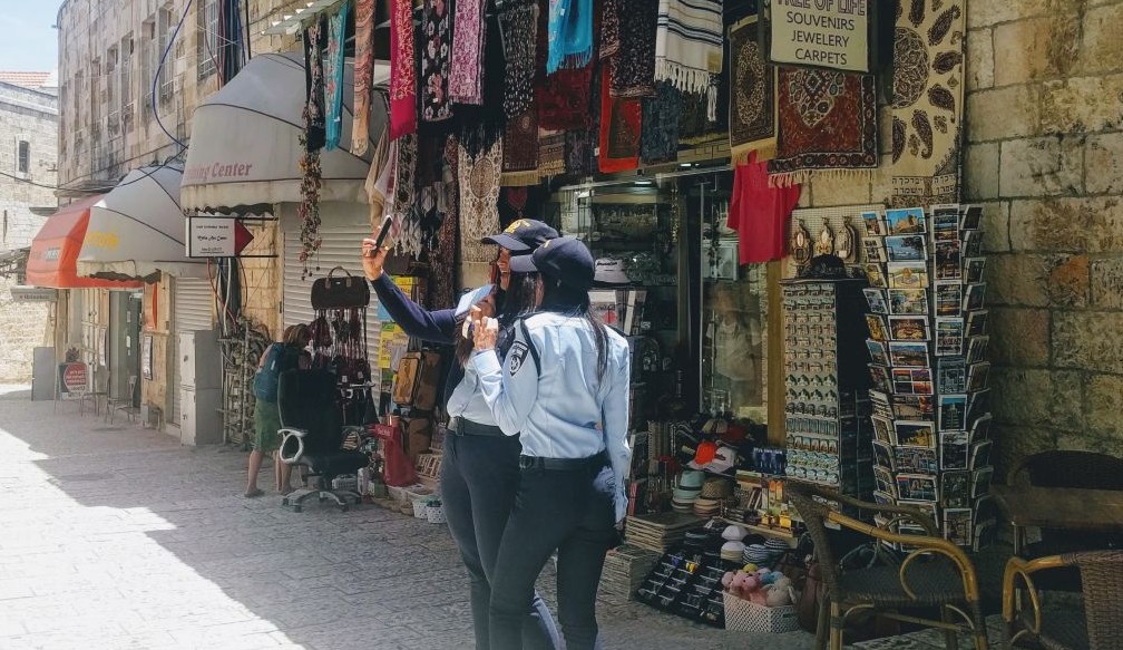 Two police officers on duty in the Old City‘s Christian Quarter ahead of the Trump visit take a selfie on May 22, 2017. "The police hats they sell the tourists are just like ours!" one of the policewoman noted. (Melanie Lidman/Times of Israel) 