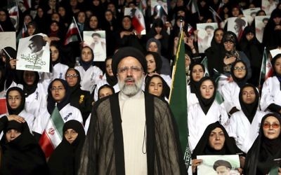 In this April 29, 2017, photo, Iranian cleric and presidential candidate Ebrahim Raisi, center, stands among his supporters, during a campaign rally in Tehran, Iran. (AP/Ebrahim Noroozi)