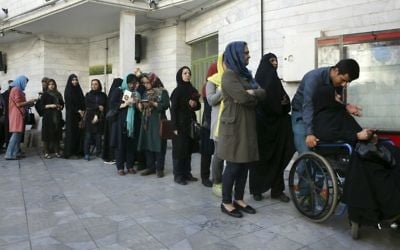 Iranian voters queue at a polling station for the presidential and municipal council election in Tehran, Iran, Friday, May 19, 2017. (AP Photo/Vahid Salemi)