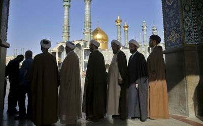 Iranian clerics queue to vote for the presidential and municipal councils elections, in the city of Qom, south of the capital Tehran, Iran, Friday, May 19, 2017. (AP Photo/Ebrahim Noroozi)