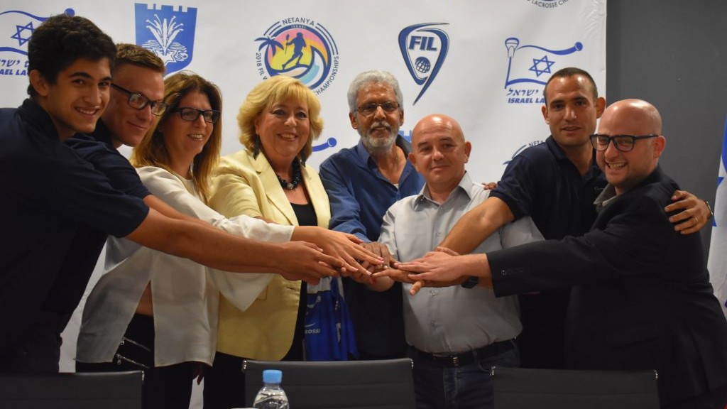 Netanya Mayor Mariam Feirberg-Ikar (C-L) and ILA head Scott Neiss (3rd-R) accompanied by Team Israel lacrosse players. (Courtesy) Netanya Mayor Mariam Feirberg-Ikar (C-L) and ILA head Scott Neiss (3rd-R) accompanied by Team Israel lacrosse players. (Courtesy)