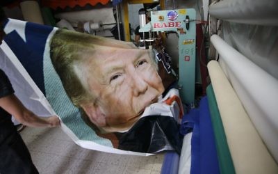 Palestinians work on a poster depicting US President Donald Trump in preparations for visit in the West Bank town of Bethlehem, Monday, May 22, 2017.(AP/Nasser Shiyoukhi)
